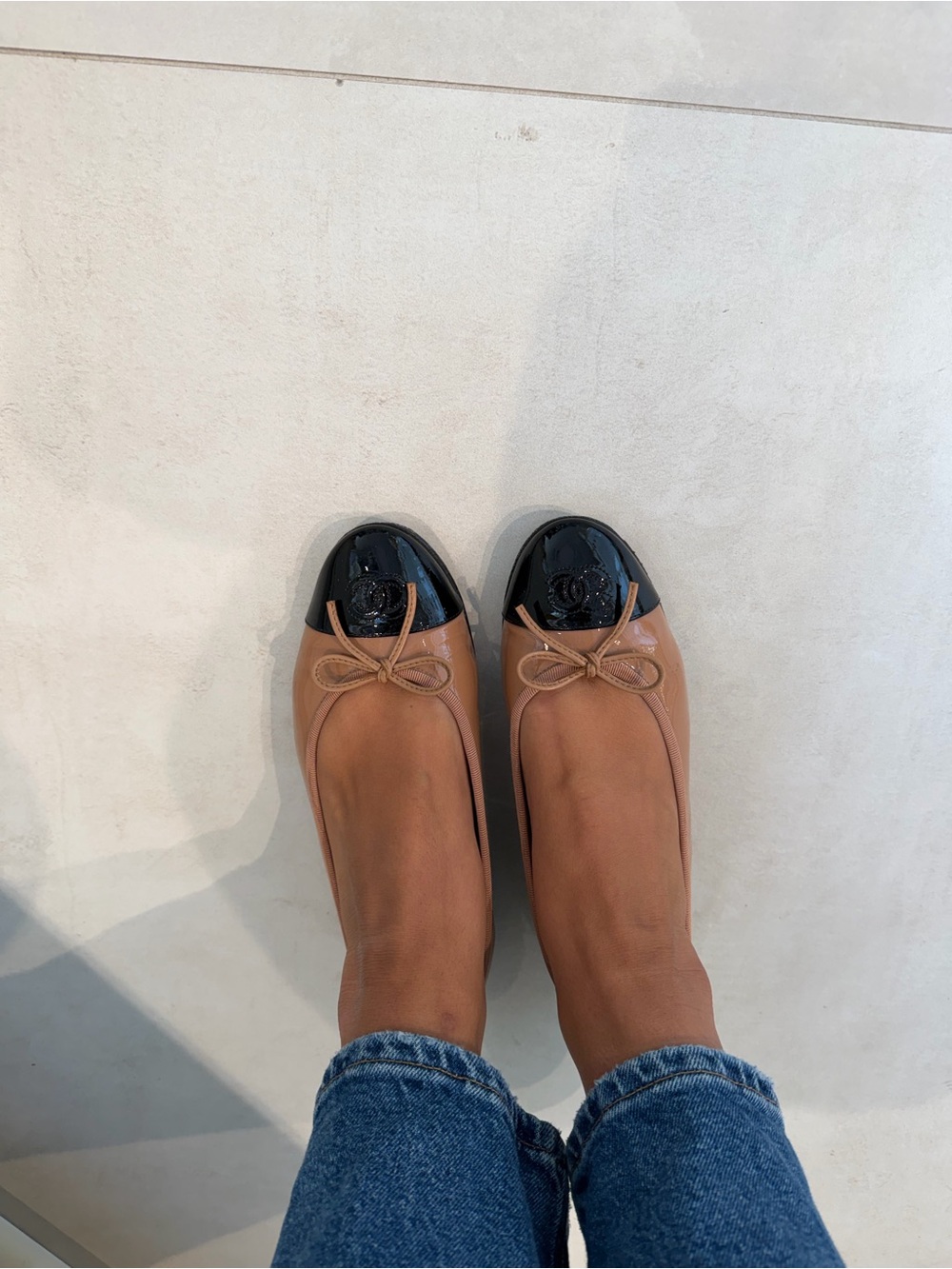 CHANEL Two-Tone Tan and Black Cap-Toe Ballet Flats